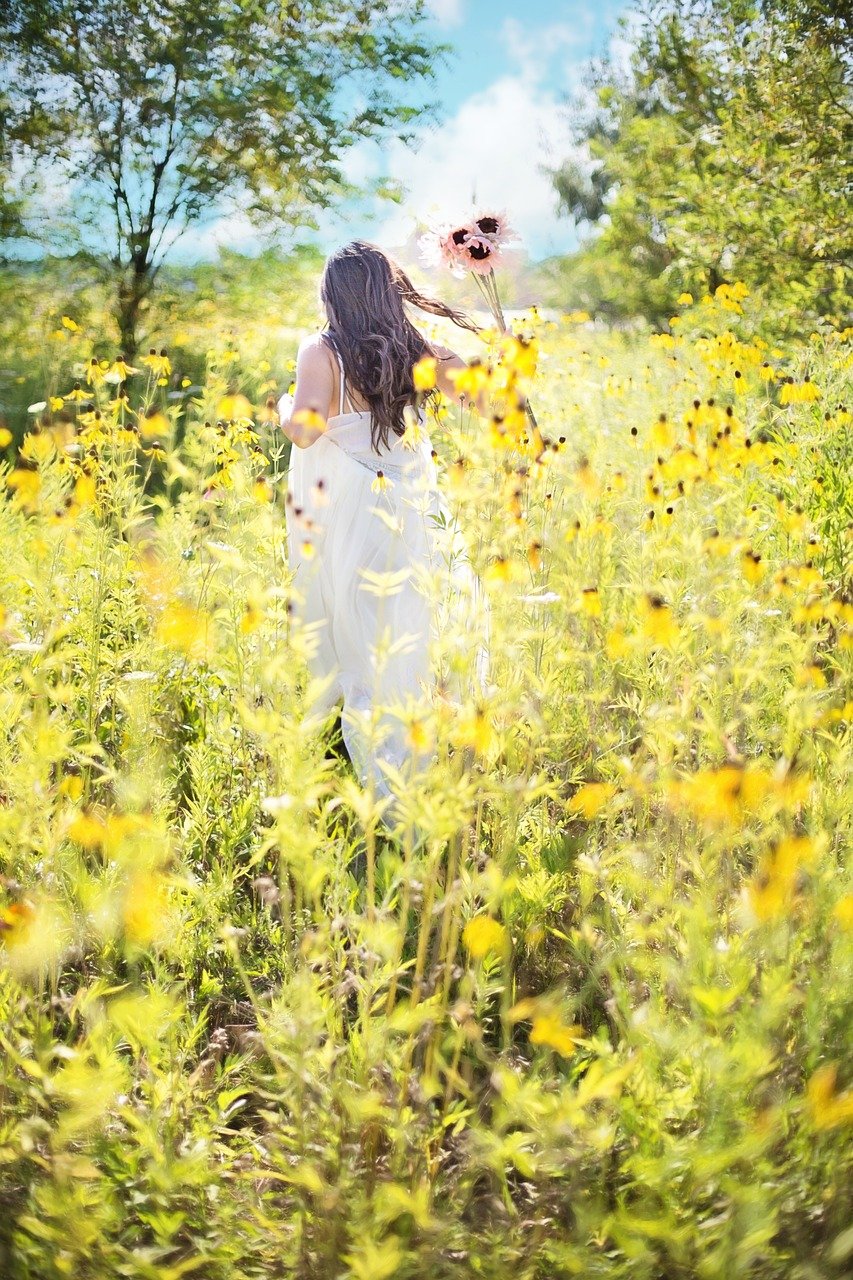 Individual Therapy 6 Woman running in sunflower field, representing the healing process through trauma-informed therapy, trauma therapy, trauma counselling, childhood trauma, political trauma
