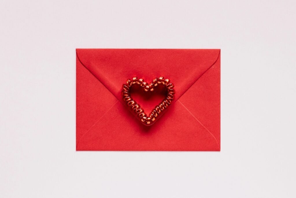 Mental Health Gift Cards 1 A red envelope with a red heart-shaped decoration on a white background, perfect for Valentine's Day.