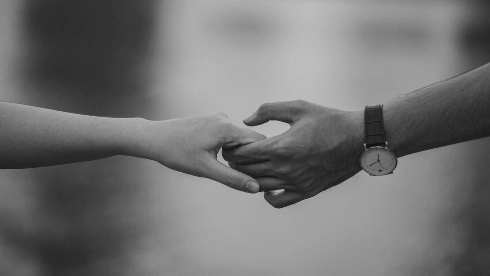 Services 7 Monochrome image of two hands holding, symbolizing love and connection.